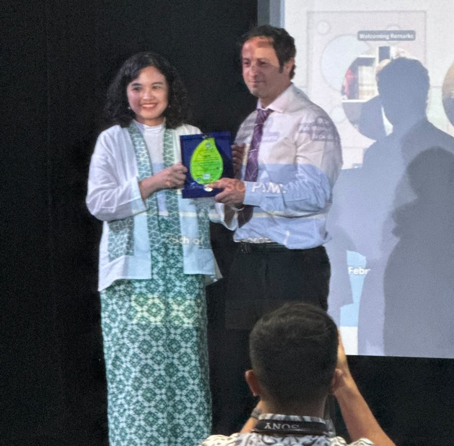 Plaque presentation on stage at an event